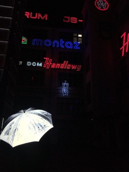 Wroclaw neon signs and lit umbrella art installation at night