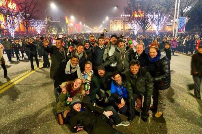 Foreign tour group celebrating New Year amid Pyongyang street lights and crowds