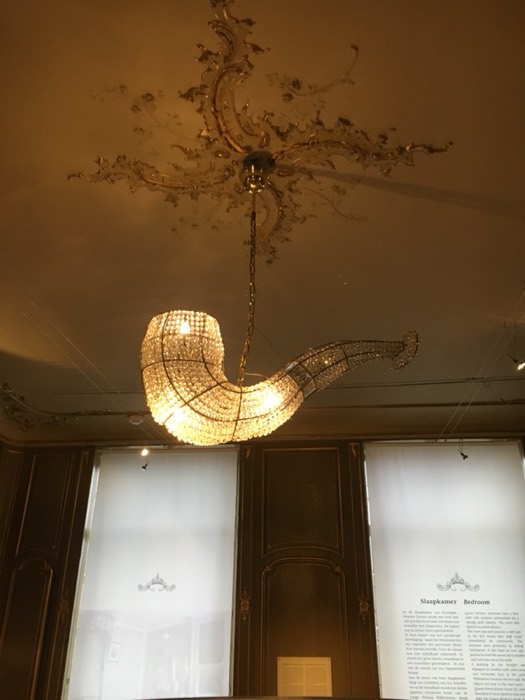 Ornate crystal chandelier and rococo ceiling in former palace