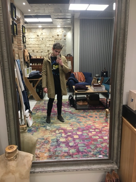 Joshua: mirror selfie in stylish Paris shop with colorful rug