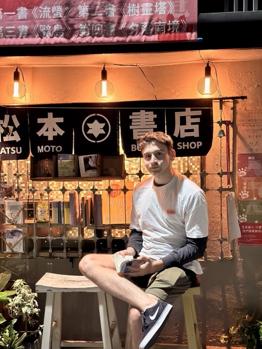 Joshua: sitting outside Matsumoto bookshop under warm lights