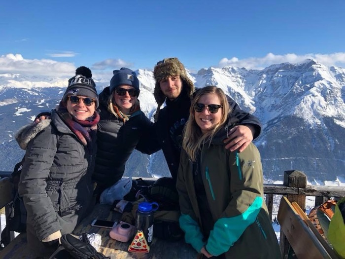 Joshua: with friends at mountaintop table, snowy Alps panorama