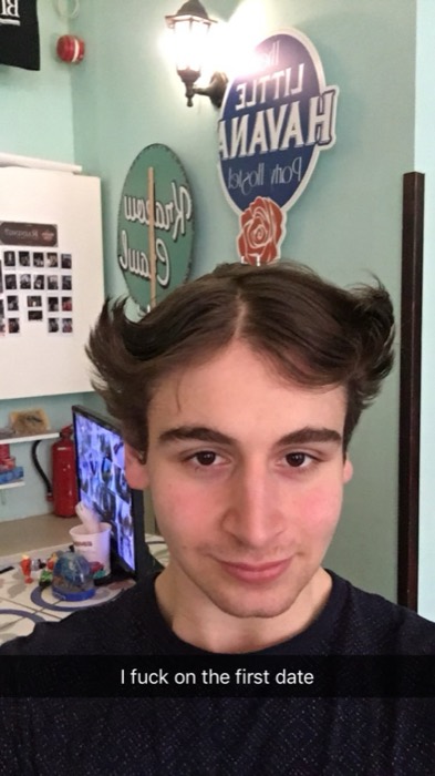 Joshua: deadpan selfie at hostel desk, crude Snapchat caption