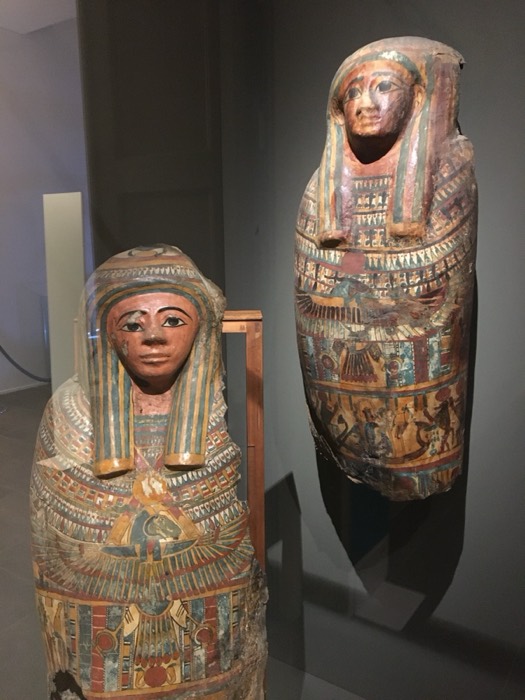Two ornate painted Egyptian mummy cases on display