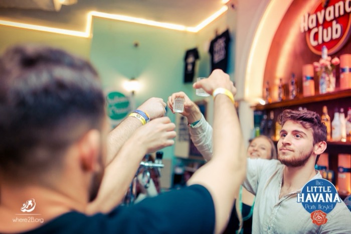 Joshua: clinking shots at Little Havana bar, Havana Club sign