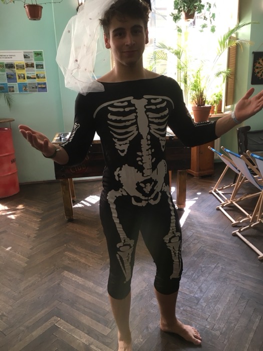 Joshua: in skeleton bodysuit and bridal veil at hostel, arms out
