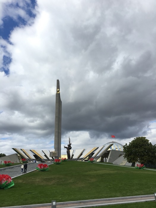 Bronze trumpeter Victory statue with Belarusian flag flowers
