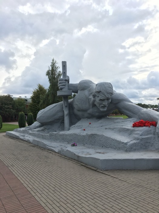 Brest Fortress Thirst soldier statue reaching, with red flowers