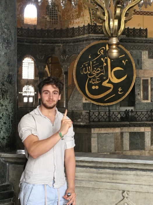 Joshua: posing inside Hagia Sophia beside Arabic calligraphy roundel