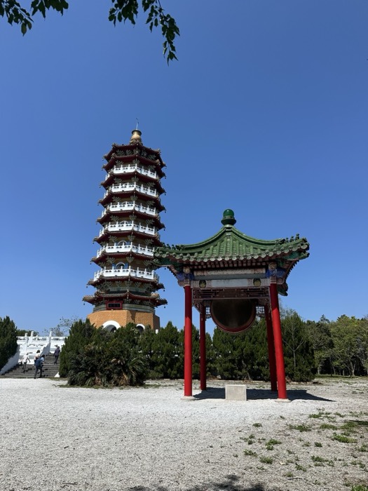 Ci'en Pagoda and green-roofed bell pavilion against deep blue sky