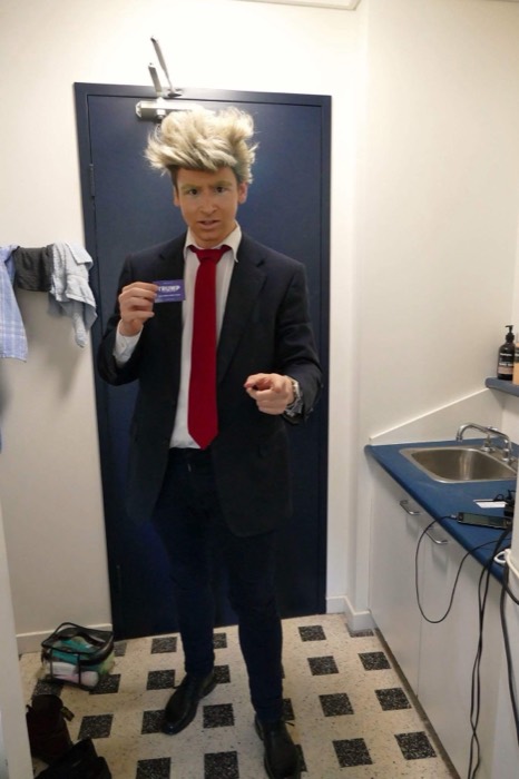 Joshua: full Donald Trump Halloween costume, blonde wig, holding Trump card