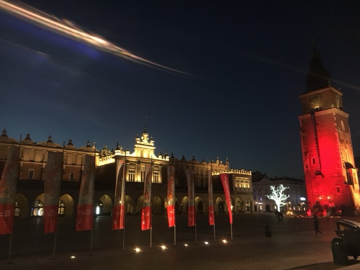Krakow Main Square at night, lit Cloth Hall and red Town Hall Tower