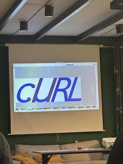 curl logo design in Inkscape projected at conference