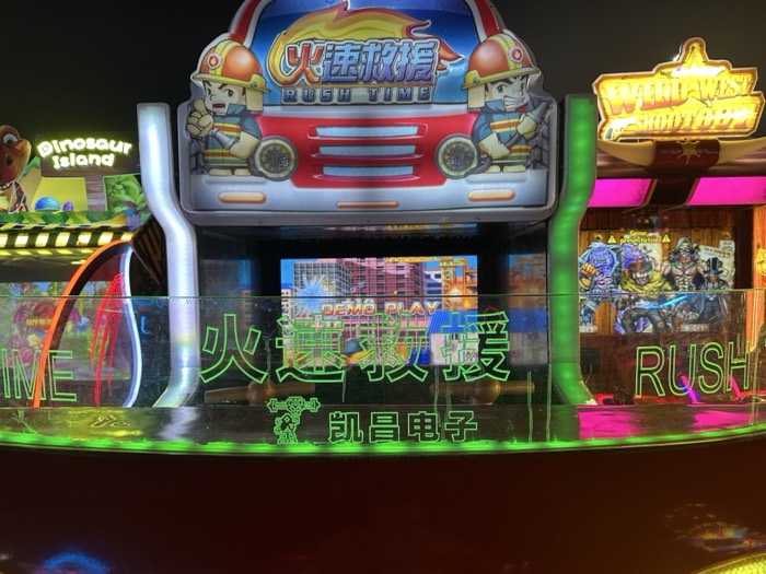 Neon-lit Taiwanese arcade machines, Rush Time and shootout games
