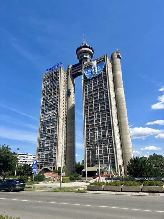 Genex Tower (Western City Gate) brutalist twin towers against blue sky