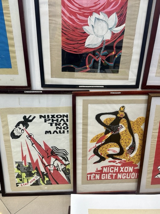 Anti-Nixon Vietnam War propaganda posters framed on gallery wall