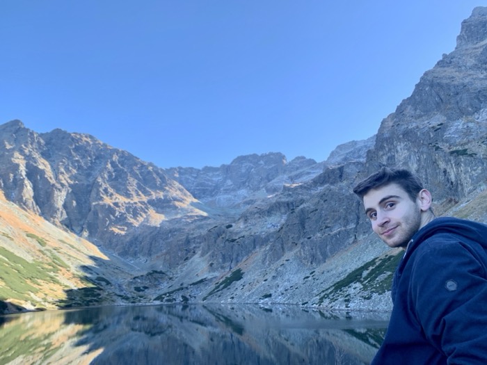 Joshua: selfie at mirror-still Tatra mountain lake at golden hour