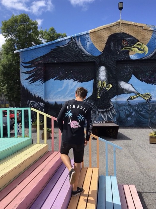 Joshua: climbing rainbow steps toward giant eagle mural