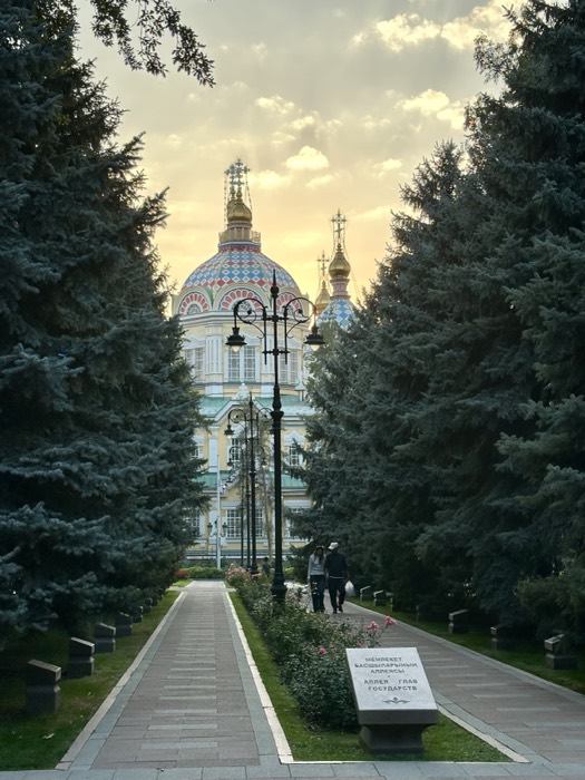 Zenkov Ascension Cathedral domes at golden sunset, framed by tall firs
