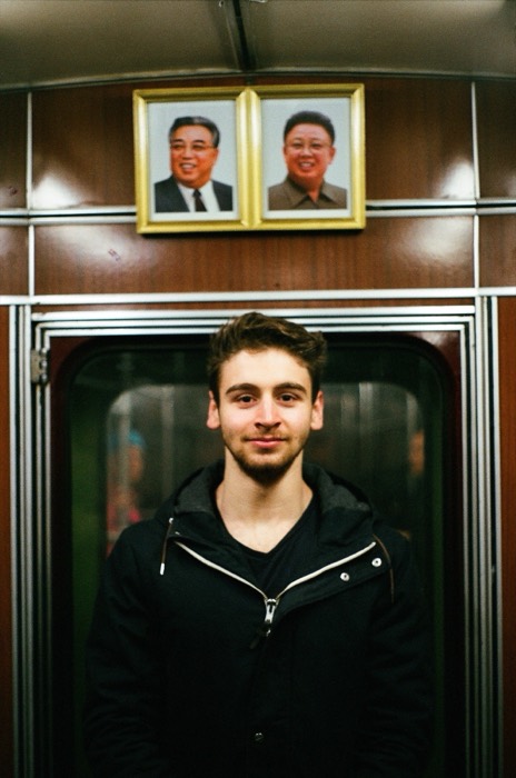 Joshua: in Pyongyang metro beneath Kim Il-sung and Kim Jong-il portraits