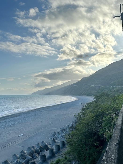 Sweeping Taiwan east-coast beach, mountains and tetrapods at dusk