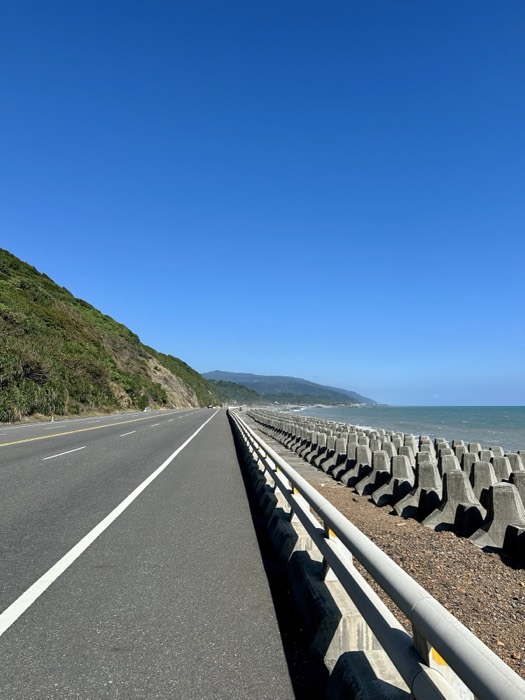 Edited near-duplicate of coastal highway with tetrapods and mountains.