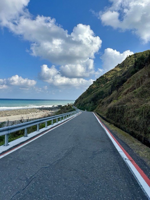 Edited duplicate of coastal cycling road above turquoise beach