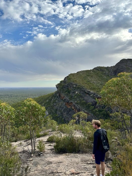 Joshua: gazing over Grampians ridgeline and plains from cliff