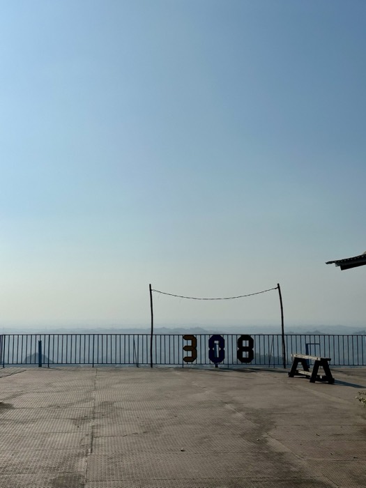 Hazy hilltop viewpoint with 308 marker numbers on railing