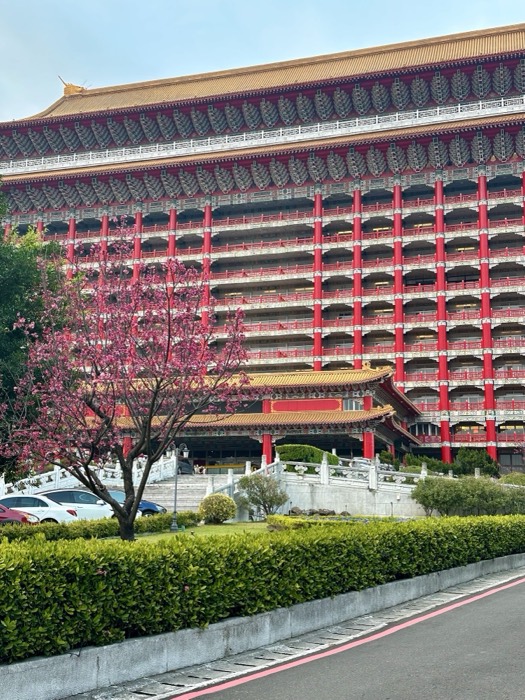 Grand Hotel Taipei red palace facade with cherry blossom tree
