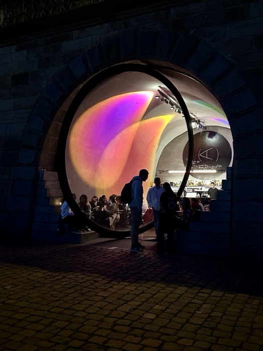 Edited night bar in circular tunnel portal, near-identical to original.