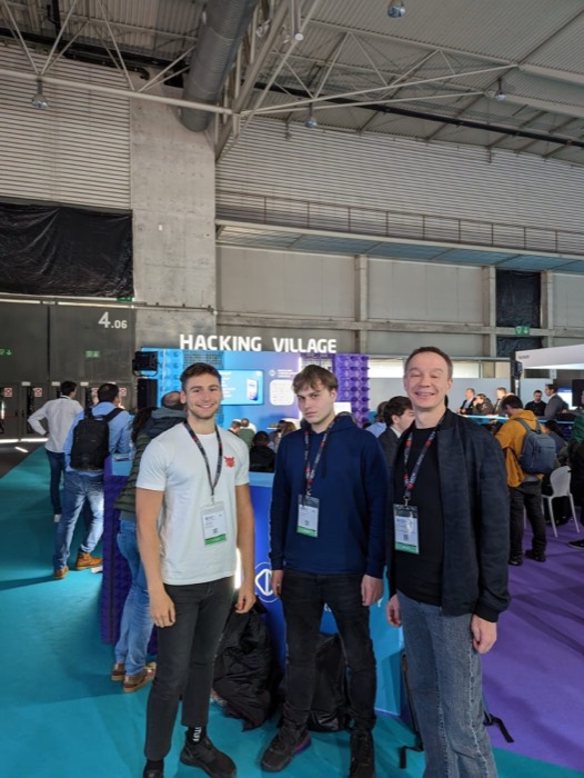 Joshua: with two colleagues at conference Hacking Village stand