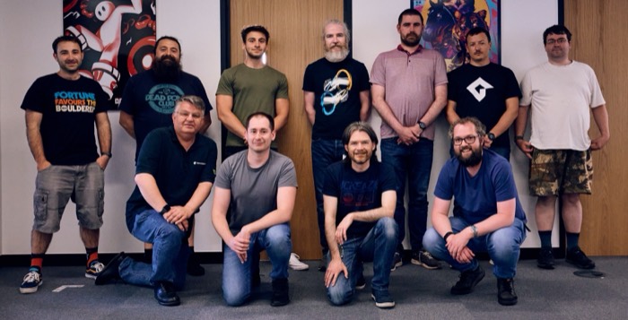 Joshua: game studio team group photo before games posters